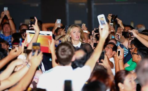 SINGAPORE - OCTOBER 18:   Maria Sharapova of Russia arrives at the Marina Bay Sands shopping centre for the draw ceremony prior to the start of the BNP Paribas WTA Finals at Singapore Sports Hub on October 18, 2014 in Singapore.  (Photo by Clive Brunskill/Getty Images)