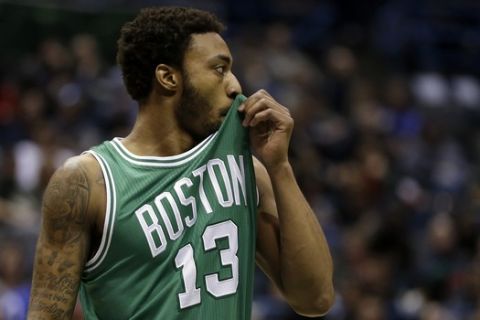 Boston Celtics' James Young wipes his face during an NBA basketball game against the Milwaukee Bucks Wednesday, April 15, 2015, in Milwaukee. (AP Photo/Aaron Gash) 