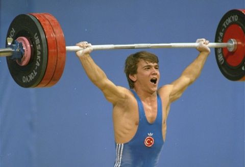Naim Suleymanoglu of Turkey yells it out during one of the lifts which won him a gold medal in the 60-kilogram Olympic weightlifting competition Tuesday September 20, 1988.  He set a world record of 152.5 kilos in the snatch.