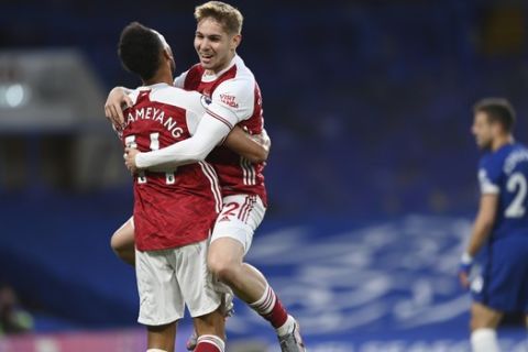 Arsenal's Emile Smith Rowe, right, celebrates with his teammate Pierre-Emerick Aubameyang after scoring his side's opening goal during the English Premier League soccer match between Chelsea and Arsenal at Stamford Bridge stadium in London, England, Wednesday, May 12, 2021. (Shaun Botterill, Pool via AP)