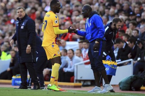 Crystal Palace's Christian Benteke celebrates scoring his side's first goal of the game against Liverpool with Mamadou Sakho, right, during the English Premier League soccer match at Anfield in Liverpool, England, Sunday April 23, 2017. (Peter Byrne/PA via AP)