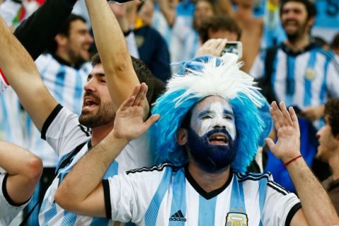 SAO PAULO, BRAZIL - JULY 09:  Argentina fans celebrate after defeating the Netherlands in a penalty shootout during the 2014 FIFA World Cup Brazil Semi Final match between the Netherlands and Argentina at Arena de Sao Paulo on July 9, 2014 in Sao Paulo, Brazil.  (Photo by Clive Rose/Getty Images)
