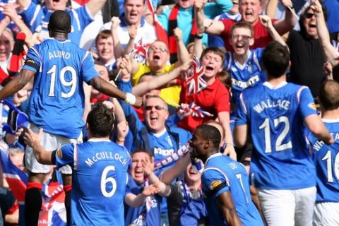 Rangers' Sone Aluko, left, celebrates his goal with his teammates during their Scottish Premier League soccer match against Celtic at Ibrox, Glasgow, Scotland, Sunday, March 25, 2012. (AP Photo/Scott Heppell)