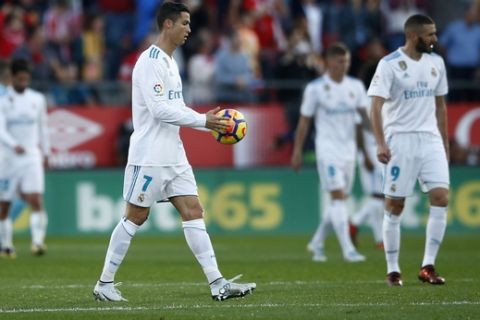 Real Madrid's Cristiano Ronaldo carries the ball to the centre sport to restart the game after Girona scored their second goal of the game during the La Liga soccer match between Girona and Real Madrid at the Montilivi stadium in Girona, Spain, Sunday, Oct. 29, 2017. (AP Photo/Manu Fernandez)
