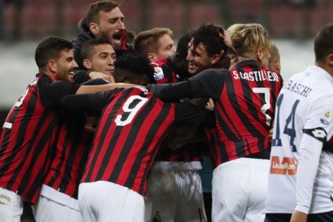 AC Milan players celebrate after Alessio Romagnoli scored his side' second goal during the Serie A soccer match between AC Milan and Genoa at the San Siro Stadium in Milan, Italy, Wednesday, Oct. 31, 2018. AC Milan won 2-0. (AP Photo/Antonio Calanni)