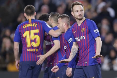 FC Barcelona's Ivan Rakitic, right, celebrates his side's second goal during a Spanish Copa del Rey soccer match between FC Barcelona and Sevilla at the Camp Nou stadium in Barcelona, Spain, Wednesday, Jan. 30, 2019. (AP Photo/Manu Fernandez)