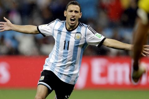 Argentina's Maxi Rodriguez celebrates after scoring the winning goal during a penalty shootout after extra time during the World Cup semifinal soccer match between the Netherlands and Argentina at the Itaquerao Stadium in Sao Paulo Brazil, Wednesday, July 9, 2014. Argentina defeated the Netherlands 4-2 in a penalty shootout after a 0-0 tie to advance to the finals. (AP Photo/Natacha Pisarenko)