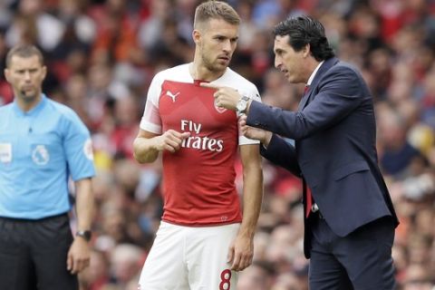 Arsenal manager Unai Emery gives instructions to Arsenal's Aaron Ramsey during the English Premier League soccer match between Arsenal and Manchester City at the Emirates stadium in London, England, Sunday, Aug. 12, 2018. (AP Photo/Tim Ireland)