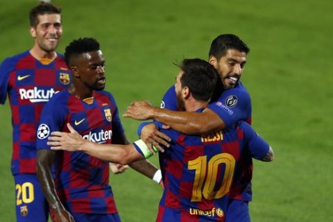 Barcelona's Lionel Messi celebrates with teammates after scoring his side's second goal during the Champions League round of 16, second leg soccer match between Barcelona and Napoli at the Camp Nou Stadium in Barcelona, Spain, Saturday, Aug. 8, 2020. (AP Photo/Joan Monfort)