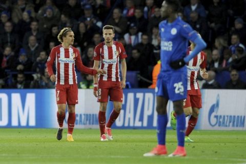 Atletico Madrid's Saul Niguez, center, walks back up the pitch after scoring with Antoine Griezmann, left, during the Champions League quarterfinal second leg soccer match between Leicester City and Atletico Madrid at King Power Stadium, Leicester, England, Tuesday, April 18, 2017. (AP Photo/Rui Vieira)