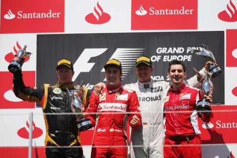VALENCIA, SPAIN - JUNE 24:  (L-R) Second placed Kimi Raikkonen of Finland and Lotus, race winner Fernando Alonso of Spain and Ferrari, third placed Michael Schumacher of Germany and Mercedes GP and Alonsos' race engineer Andrea Stella celebrate on the podium following the European Grand Prix at the Valencia Street Circuit on June 24, 2012 in Valencia, Spain.  (Photo by Mark Thompson/Getty Images)