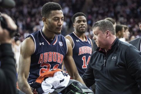 Auburn forward Anfernee McLemore (24) is carted off the court after an injury during the first half of the team's NCAA college basketball game against South Carolina on Saturday, Feb. 17, 2018, in Columbia, S.C. South Carolina defeated Auburn 84-75. (AP Photo/Sean Rayford)