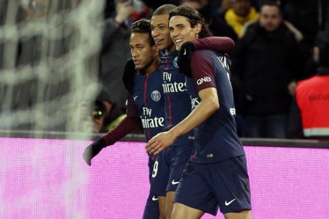 PSG's Neymar, right, celebrates with teammate Edinson Cavani, right, and Kylian Mbappe, center, during his French League One soccer match between Paris-Saint-Germain and Dijon, at the Parc des Princes stadium in Paris, France, Wednesday, Jan.17, 2018. (AP Photo/Thibault Camus)