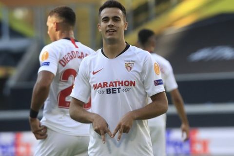 Sevilla's Sergio Reguilon celebrates after scoring his side's first goal during the Europa League, round of 16 soccer match between Roma and Sevilla, at the Schauinsland-Reisen-Arena in Duisburg, Germany, Thursday, Aug. 6, 2020. (Wolfgang Rattay/Pool Photo via AP)