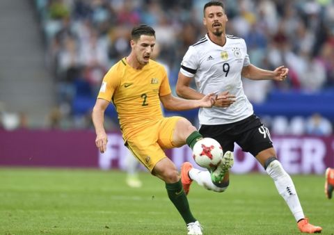 Australia's Milos Degenek, left, and Germany's Sandro Wagner go for the ball during the Confederations Cup, Group B soccer match between Australia and Germany, at the Fisht Stadium in Sochi, Russia, Monday, June 19, 2017. (AP Photo/Martin Meissner)