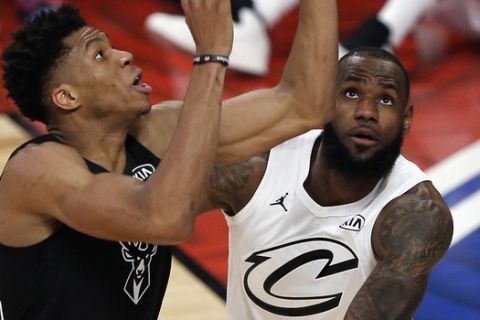 Team Stephen's forward Giannis Antetokounmpo, left, of the Milwaukee Bucks reaches for a rebound against Team LeBron's forward LeBron James of the Cleveland Cavaliers during the first half of an NBA All-Star basketball game, Sunday, Feb. 18, 2018, in Los Angeles. (AP Photo/Alex Gallardo)