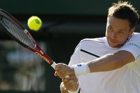 Sweden's Robin Soderling returns a shot to Australia's Bernard Tomic during their match at the All England Lawn Tennis Championships at Wimbledon, Saturday, June 25, 2011. (AP Photo/Alastair Grant)