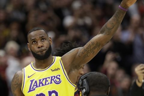 Los Angeles Lakers' LeBron James acknowledges the Cleveland fans during a video tribute to James during the first half of an NBA basketball game between the Lakers and the Cleveland Cavaliers, Wednesday, Nov. 21, 2018, in Cleveland. (AP Photo/Tony Dejak)