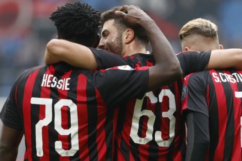 AC Milan's Franck Kessie, left, celebrates with his teammates Patrick Cutrone, center, and Samuel Castillejo at the end off the Serie A soccer match between AC Milan and Parma at the San Siro Stadium, in Milan, Italy, Sunday, Dec. 2, 2018. Ac Milan won 2-1. (AP Photo/Antonio Calanni)
