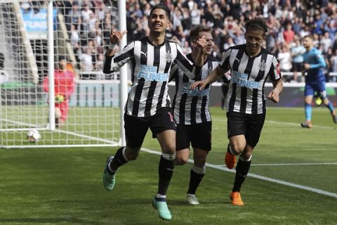 Newcastle United's Ayoze Perez, left, celebrates scoring his side's first goal of the game during the English Premier League soccer match between Newcastle United and Arsenal at St James' Park, Newcastle, England, Sunday, April 15, 2018. (Owen Humphreys/PA via AP)