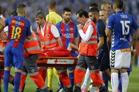Barcelona's Javier Mascherano is carried in a stretcher by Red Cross members after colliding with Alaves' Marcos Llorente during the Copa del Rey final soccer match between Barcelona and Alaves at the Vicente Calderon stadium in Madrid, Saturday, May 27, 2017. (AP Photo/Daniel Ochoa de Olza)