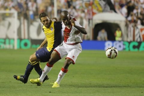 Rayo's Kakuta, right, vies for the ball with Atletico's Koke, left, during a Spanish La Liga soccer match between Rayo Vallecano and Atletico Madrid at the Vallecas stadium in Madrid, Spain, Monday, Aug. 25, 2014. (AP Photo/Andres Kudacki)