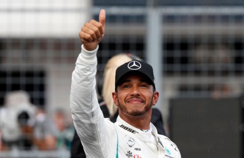 Mercedes driver Lewis Hamilton of Britain celebrates after setting a pole position in the qualifying session for the Hungarian Formula One Grand Prix, at the Hungaroring racetrack in Mogyorod, northeast of Budapest, Saturday, July 28, 2018. The Hungarian Grand Prix will be held on Sunday. (AP Photo/Laszlo Balogh)