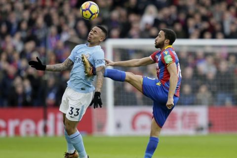 Manchester City's Gabriel Jesus, left, competes for the ball with Crystal Palace's Andros Townsend during the English Premier League soccer match between Crystal Palace and Manchester City at Selhurst Park in London, Sunday Dec. 31, 2017. (AP Photo/Tim Ireland)