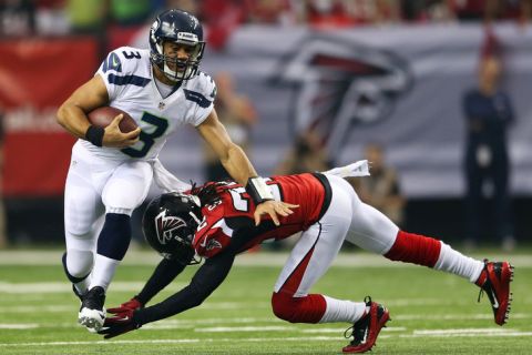 ATLANTA, GA - JANUARY 13:   Russell Wilson #3 of the Seattle Seahawks tries to avoid the tackle of  Jacquizz Rodgers #32 of the Atlanta Falcons in the first quarter during the NFC Divisional Playoff Game at Georgia Dome on January 13, 2013 in Atlanta, Georgia.  (Photo by Mike Ehrmann/Getty Images)