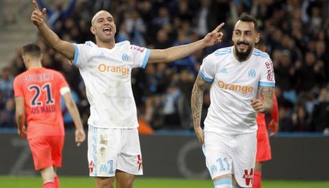 Marseille's Konstantinos Mitroglou, right, celebrates with Aymen Abdennour, after scoring during the League One soccer match between Marseille and Caen, at the Velodrome stadium, in Marseille, southern France, Sunday, Nov. 5, 2017. (AP Photo/Claude Paris)