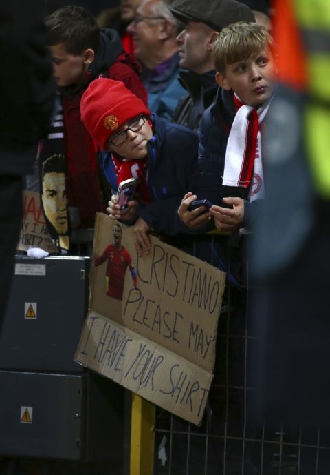 A child holds a sign for Juventus forward Cristiano Ronaldo during the Champions League group H soccer match between Manchester United and Juventus at Old Trafford, Manchester, England, Tuesday, Oct. 23, 2018. (AP Photo/Dave Thompson)