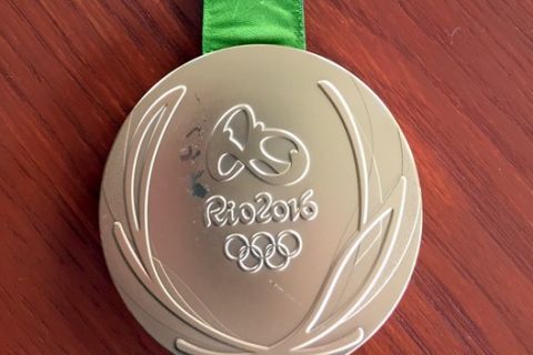 This photo provided by Kevin Snyder show Kyle Snyder's damaged gold metal from the 2016 Rio Olympics on Tuesday, May 23, 2017, in Maryland. The medal will soon replaced by the IOC and Rio organizers because of damage. Snyder and Helen Maroulis, another U.S. gold medalist wrestler, are among a group of more than 100 athletes from around the world with defective Olympic medals. (Kevin Snyder via AP)