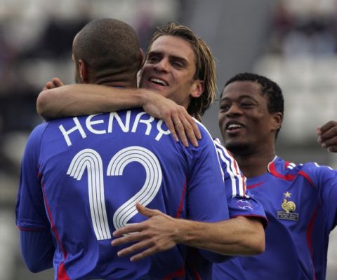 French soccer player Thierry Henry is congratulated by teammate Jerome Rothen, center, and Patrice Evra, right, after scoring the second goal for France during a qualifying match for the Euro 2008 between France and the Faroe Islands, Saturday Oct. 13, 2007, at the Torsvollur stadium in Torshavn, Faroe Islands.(AP Photo/Remy de la Mauviniere)