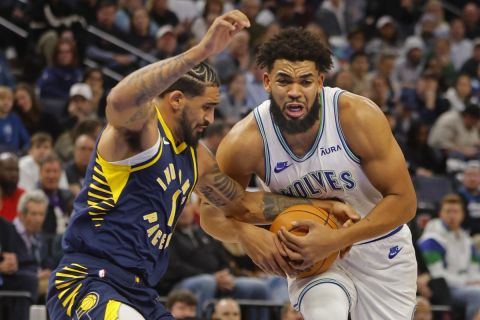 Minnesota Timberwolves forward Karl-Anthony Towns, right, tries to work past Indiana Pacers forward Obi Toppin, left, in the first quarter of an NBA basketball game Saturday, Dec. 16, 2023, in Minneapolis. (AP Photo/Bruce Kluckhohn)