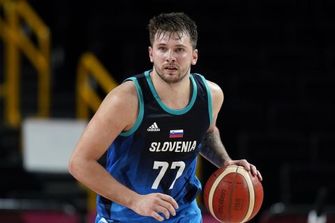 Slovenia's Luka Doncic (77) drives up court during a men's basketball semifinal round game against France at the 2020 Summer Olympics, Thursday, Aug. 5, 2021, in Saitama, Japan. (AP Photo/Charlie Neibergall)