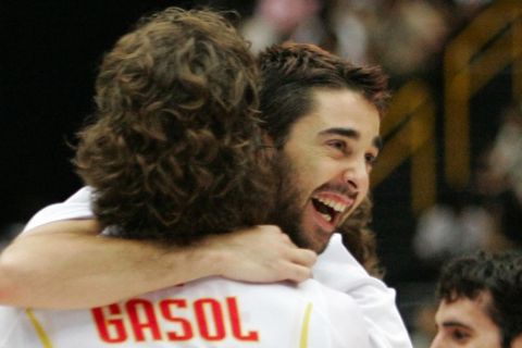 Spain's Juan Carlos Navarro jumps into the arms of teammate Pau Gasol after they defeated Lithuania in the quarterfinals of the World Basketball Championships,Tuesday, Aug. 29, 2006, in Saitama, Japan. (AP Photo/Mark J. Terrill)