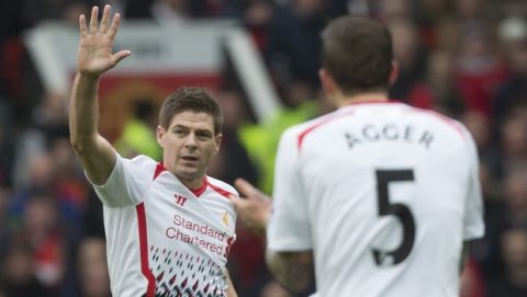 Liverpool's Steven Gerrard, left, celebrates after scoring against Manchester United during their English Premier League soccer match at Old Trafford Stadium, Manchester, England, Sunday March 16, 2014. (AP Photo/Jon Super)  