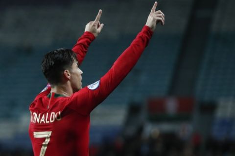 Portugal's Cristiano Ronaldo celebrates after scoring his side's second goal during the Euro 2020 group B qualifying soccer match between Portugal and Lithuania at the Algarve stadium outside Faro, Portugal, Thursday, Nov. 14, 2019. (AP Photo/Armando Franca)