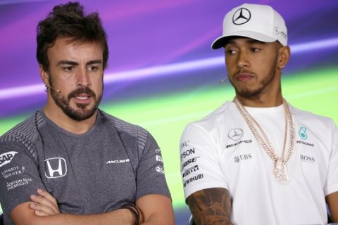 McLaren driver Fernando Alonso of Spain, left, answers a question as Mercedes driver Lewis Hamilton of Britain listens during a press conference at the track in Melbourne, Thursday, March 23, 2017. Sunday's season-opening Australian Grand Prix, where F1rule changes requiring wider tires, greater aerodynamics, bigger fuel loads and increased downforce are expected to make the heavier cars significantly faster than previous years. (AP Photo/Rick Rycroft)