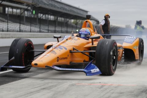 IndyCar driver Fernando Alonso, of Spain, drives out of the pit area during testing at the Indianapolis Motor Speedway in Indianapolis, Wednesday, April 24, 2019. (AP Photo/Michael Conroy)