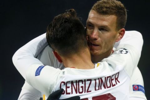 Roma's Cengiz Under, front, celebrates with Edin Dzeko after scoring his side's opening goal during the Champions League, round of 16, first-leg soccer match between Shakhtar Donetsk and Roma at the Metalist Stadium in Kharkiv, Ukraine, Wednesday, Feb. 21, 2018. (AP Photo/Efrem Lukatsky)