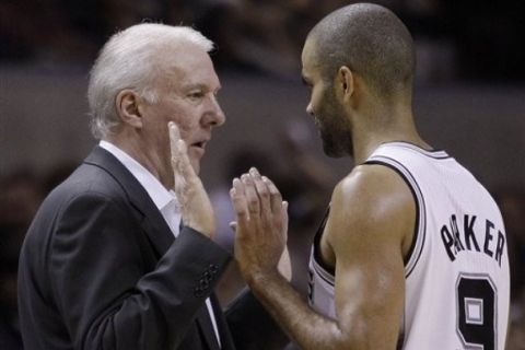 San Antonio Spurs' Tony Parker (9), of France, talks with coach Gregg Popovich, left, during the fourth quarter of an NBA basketball game against the Sacramento Kings, Wednesday, April 6, 2011, in San Antonio. (AP Photo/Eric Gay)