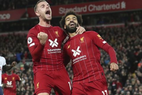 Liverpool's Mohamed Salah, right, celebrates with his teammate Jordan Henderson after scoring his side's second goal during the English Premier League soccer match between Liverpool and Tottenham Hotspur at Anfield stadium in Liverpool, England, Sunday, Oct. 27, 2019. (AP Photo/Jon Super)