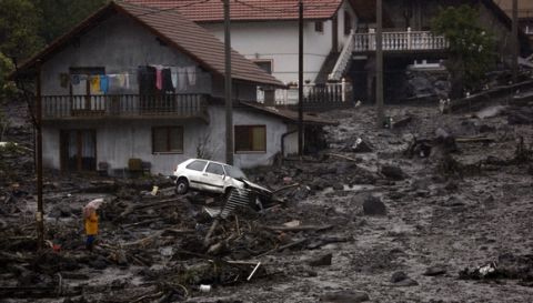 AP10ThingsToSee - Bosnian man views the scene after a landslide caused by flooding in the village of Topcic polje near Zenica, 120 kms north of Sarajevo, Bosnia, Thursday, May 15, 2014. Heavy rainfall caused the river Bosna to flood surrounding areas causing power outages and road blockades in some suburban and rural areas. (AP Photo/Amel Emric)