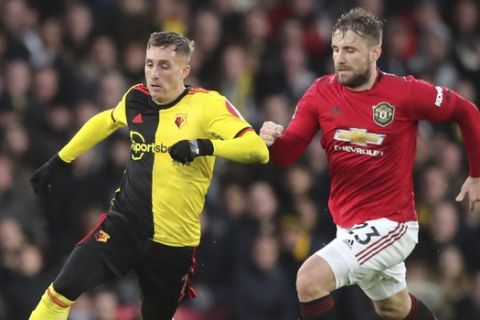 Watford's Gerard Deulofeu, left, challenges for the ball with Manchester United's Luke Shaw during the English Premier League soccer match between Watford and Manchester United, at Vicarage Road Stadium, Watford, England, Sunday, Dec. 22, 2019. (AP Photo/Petros Karadjias)