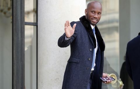 Former soccer player Didier Drogba arrives at the Elysee Palace in Paris, Wednesday, Feb.21, 2018. Former international soccer star and new Liberia President George Weah will meet with French President Emmanuel Macron in Paris Wednesday. The French presidency said discussions will notably focus on launching a fund dedicated to sports projects in Africa. (AP Photo/Francois Mori)
