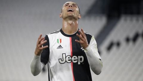Juventus' Cristiano Ronaldo reacts during an Italian Cup second leg soccer match between Juventus and AC Milan at the Allianz stadium, in Turin, Italy, Friday, June 12, 2020. The match was being played without spectators because of the coronavirus lockdown. (AP Photo/Luca Bruno)