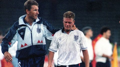 England's Paul Gascoigne cries as he is escorted off the field by team captain Terry Butcher, after his England lost a penalty shoot-out in the semi-final match of the World Cup against West Germany, July 4, 1990, in Turin, Italy. (AP Photo/Roberto Pfeil)