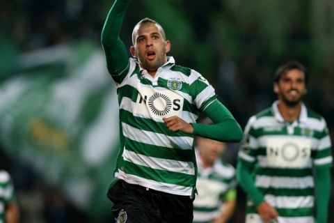 Sportings Islam Slimani, celebrates after scoring the opening goal  during a Portuguese league soccer match against Porto at the Alvalade stadium in Lisbon, Saturday, Jan. 2 2016. (AP Photo/Steven Governo)