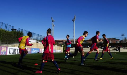 FILE - In this Jan. 8, 2011 file photo, Barcelona youth players from 'La Masia' football academy warm up at the Barcelona FC's Joan Gamper training camp in San Joan Despi, Spain. The Court of Arbitration for Sport on Tuesday Dec. 30, 2014 dismissed Barcelona's appeal and upheld the transfer ban FIFA imposed on the club for infringing regulations on registering minors as youth players. CAS said in a statement that Barcelona had breached the rules regarding the protection of minors and the registration of minors attending football academies. The ruling means Barcelona will be barred from signing any players in 2015. Barcelona is renowned for training and educating young players such as Lionel Messi and Andres Iniesta at it's La Masia academy, in the hope they develop the talent to graduate to the senior team. (AP Photo/Manu Fernandez, File)